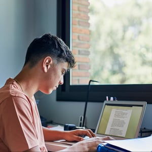 teen-boy-laptop-studying-inside-window
